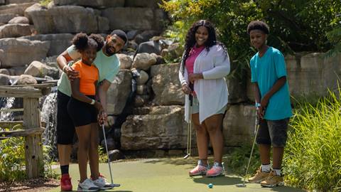 A family enjoying the Cascade Putting Course at Blue Mountain Resort