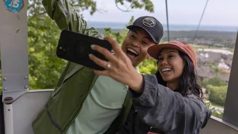 a man and woman taking a selfie on the Gondola at Blue Mountain Resort