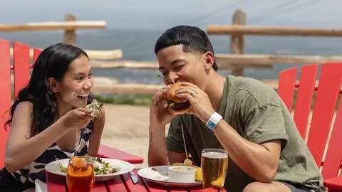 a man and woman eating burgers at Blue Mountain Summitview
