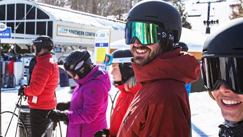 A group of people wearing ski goggles and ski jackets.