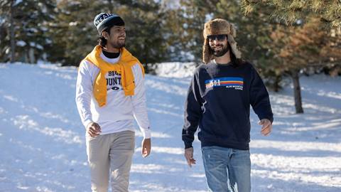 a couple of fellas walking down a snowy path wearing clothes from the Blue Mountain Supply Company
