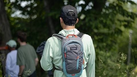 a man wearing a backpack hiking at Blue Mountain Resort