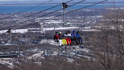 A group of people on a ski lift.