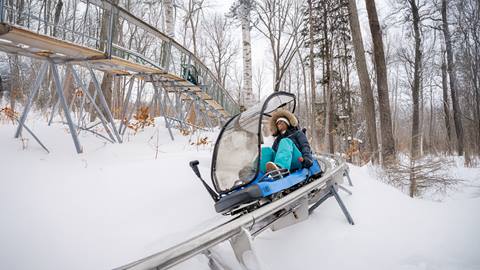 a person riding the Ridge Runner Mountain Coaster in the Winter