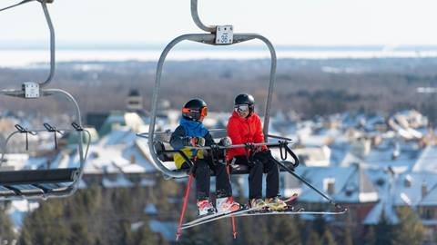 Skiers and snowboarders on chairlift