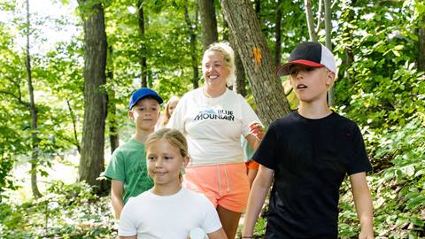 A woman and three children hiking at Blue Mountain Resort