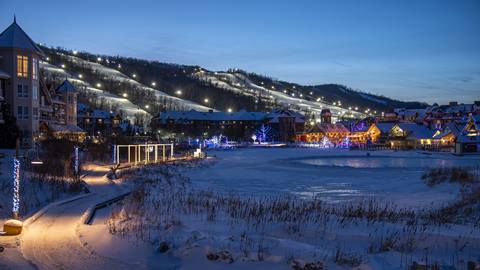 A ski resort is lit up at dusk