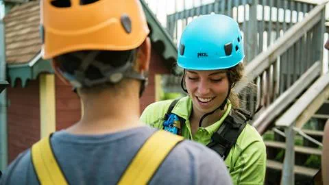 A woman wearing a helmet and smiling.