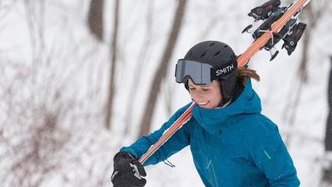 A girl walking with skis 