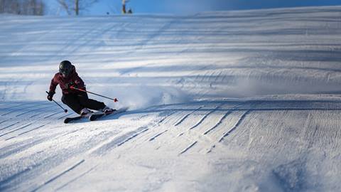 a person riding skis down a snow covered slope