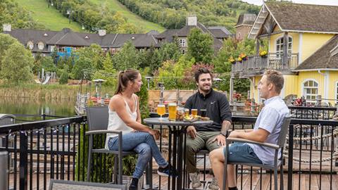 A group of friends enjoying food and beer at Blue Mountain