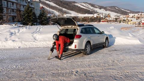 a skier getting ready inside his car