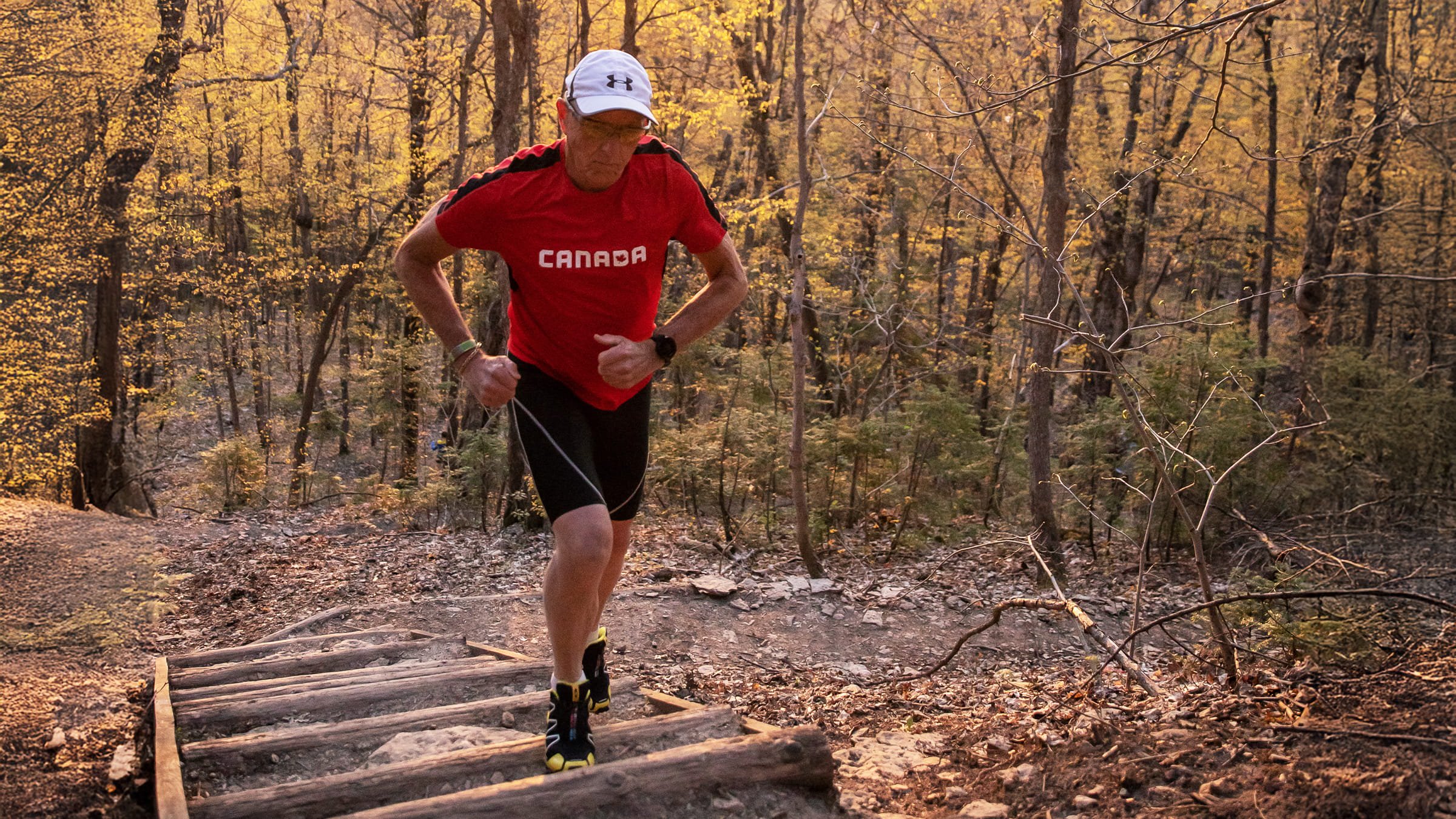 a man running up the steps of the village way trail in the Explore Park