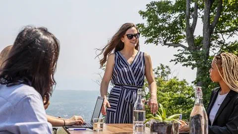 A women in sunglasses holding a meeting at the Blue Mountain Resort