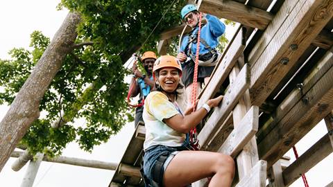 A group of people on a ropes course.