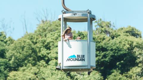 a mother and daughter riding the Open-Air Gondola