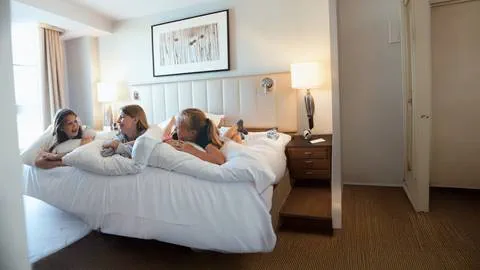 3 girls hanging out on their bed at the Westin Trillium House