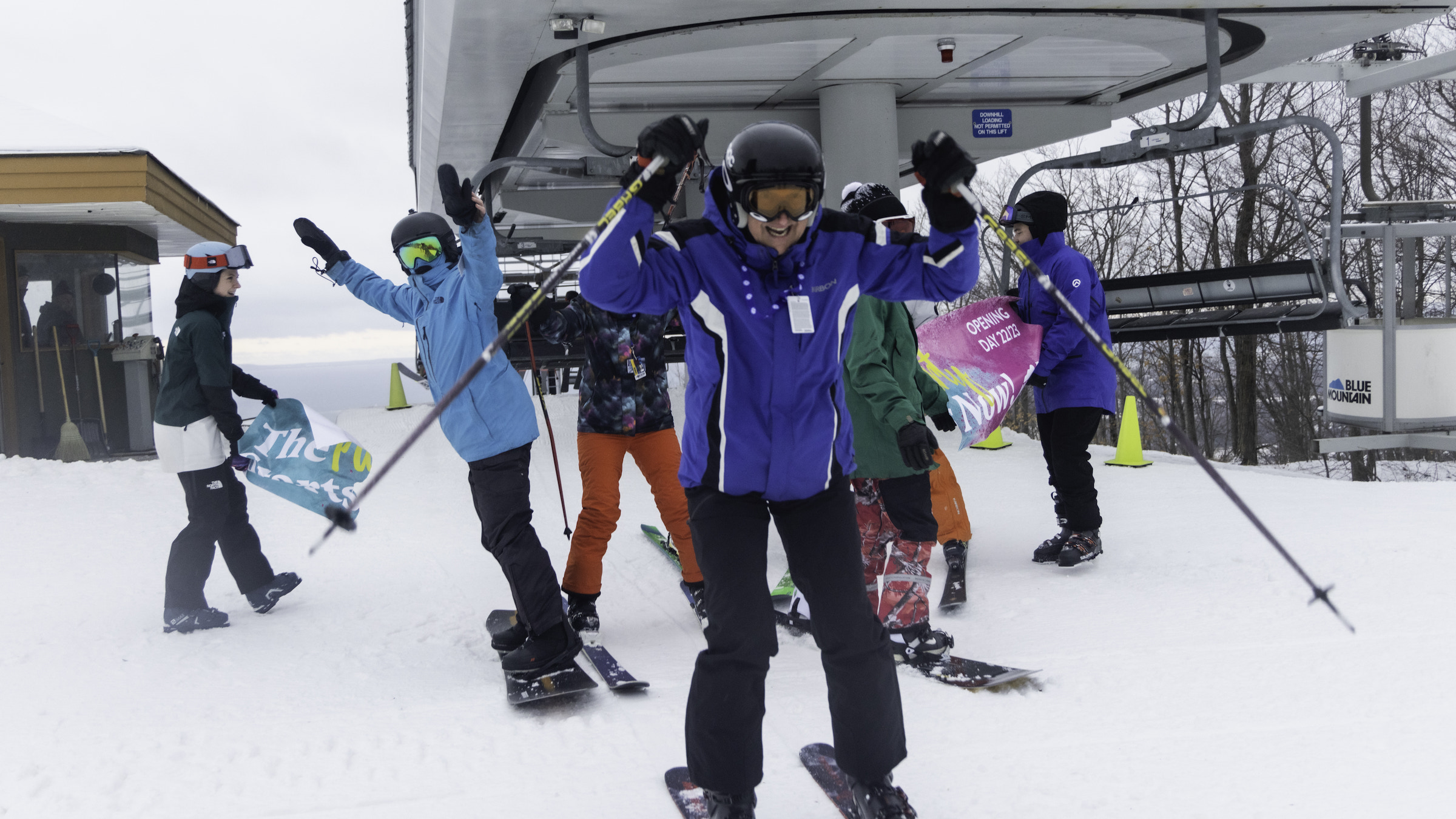 Skiers getting off chairlift