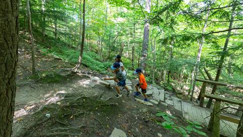 Group of kids hiking along hiking trails at Blue Mountain Resort using the Blue Mountain App