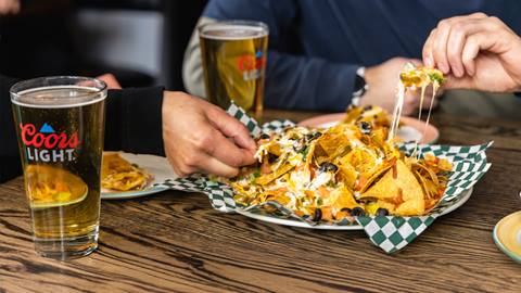 a person sitting at a table with a plate of food