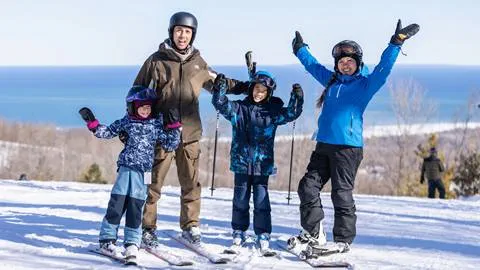 A family on skis posing for a photo.