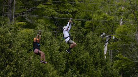 people on the Wind Rider Triple Zips at Blue Mountain Resort