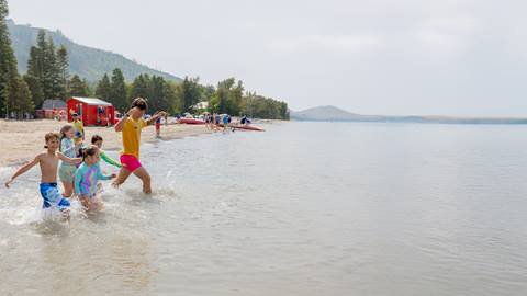 a group of people playing frisbee in the water