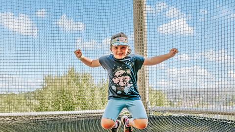 A girl bouncing in the Canopy Climb Net Adventure at Blue Mountain Resort