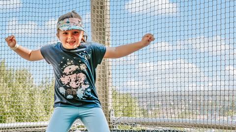 A young girl enjoying the Canopy Climb Net Adventure at Blue Mountain Resort