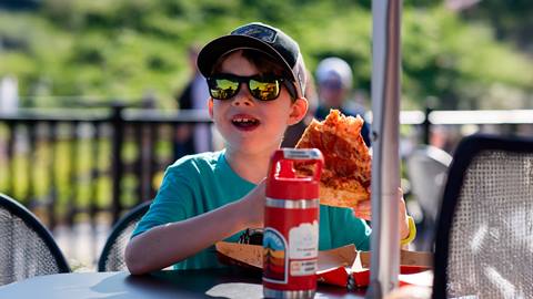 a child eating pizza at Grand Central Eatery