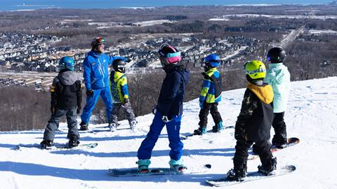 A group of people on snowboards