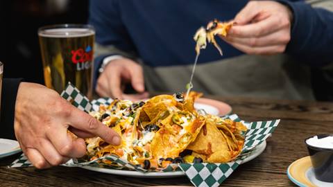 Two people enjoying nachos and beer at Blue Mountain Resorts