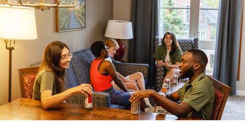 Group of friends enjoying some drinks and chatting in a Grand Georgian room