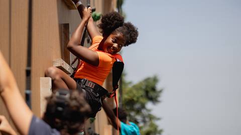 A kid climbing at the Lumber Lanes Climbing Centre