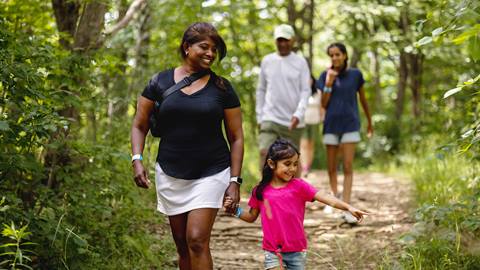 A parent and a kid enjoying a hike at Blue Mountain