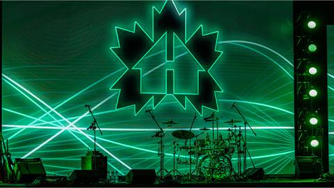 A stage with green lights and a drum kit.