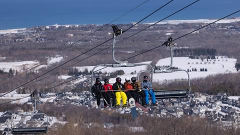 Skiers and snowboarder on the lift