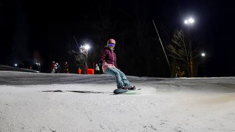 a person riding a skate board in the snow