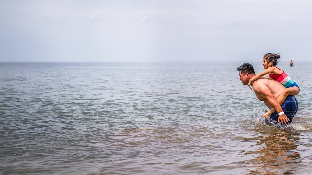 a father and daughter enjoying the Blue Mountain Beach
