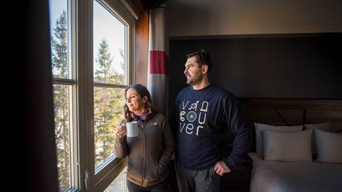 a man and a woman standing in front of a window