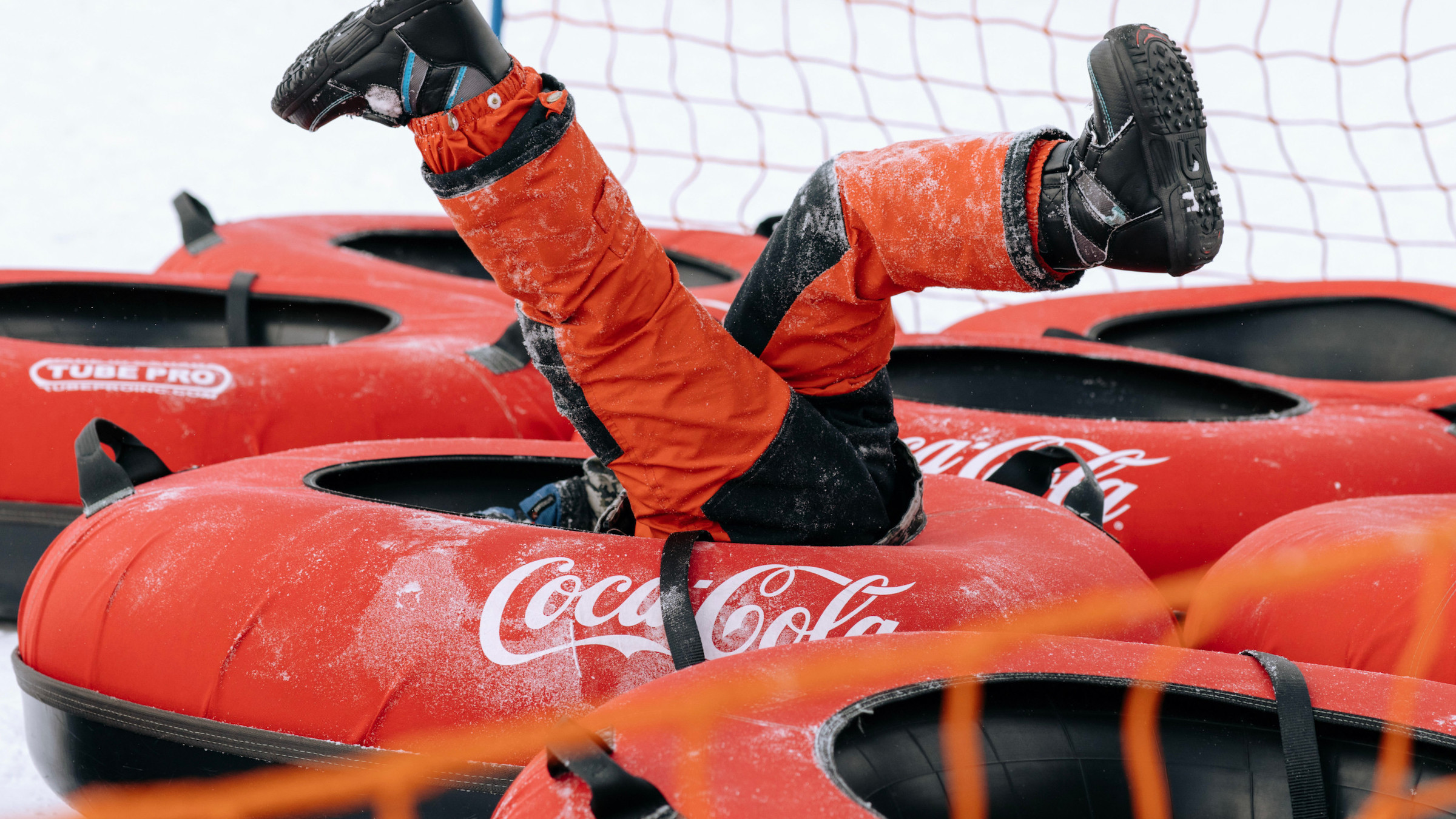 Kid upside down in tube at Blue Mountain on Activity Change and Cancellation Policy page