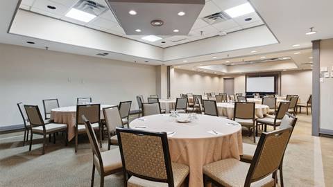 Inn conference centre meeting room with round tables and chairs
