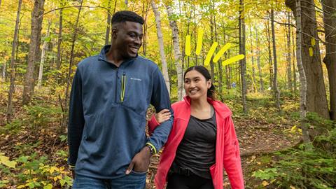 a couple hiking in the Explore Park at Blue Mountain Resort