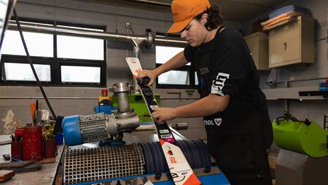 A man working on a machine in a workshop.