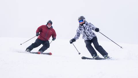 Pair of skiers riding down the mountain at Blue Mountain Resort