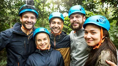 A group of people wearing helmets in the jungle.