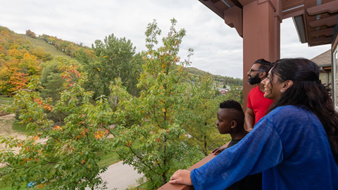 Guests in Blue Mountain Hotel looking over hill on balcony