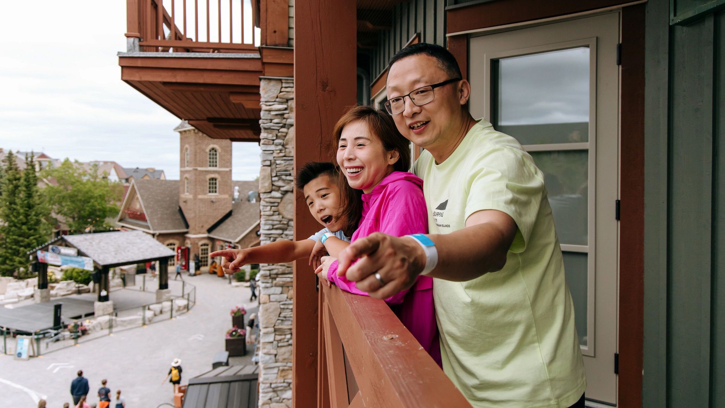 Family standing on balcony overlooking the Village at Blue Mountain Resort