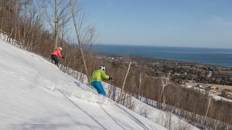 Pair of skiers on hill during spring skiing at Blue Mountain