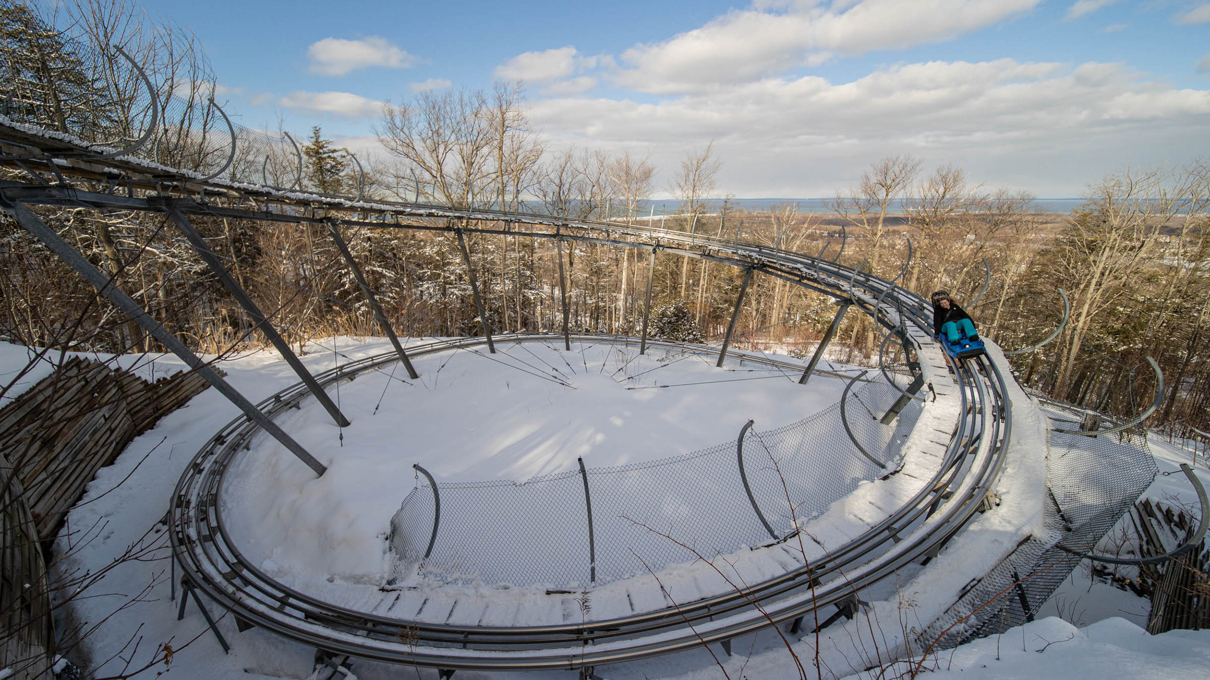 Person riding the Ridge Runner Mountain Coaster in the Winter with Play All Day
